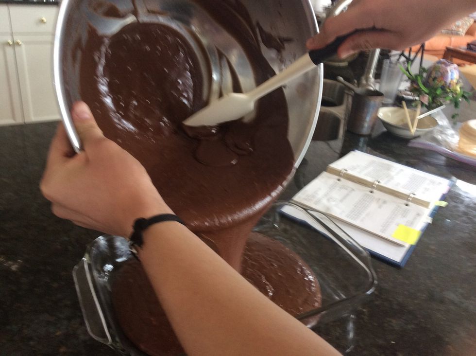 Use the other spatula to help you scrape any excess mixture off the side into the pan.