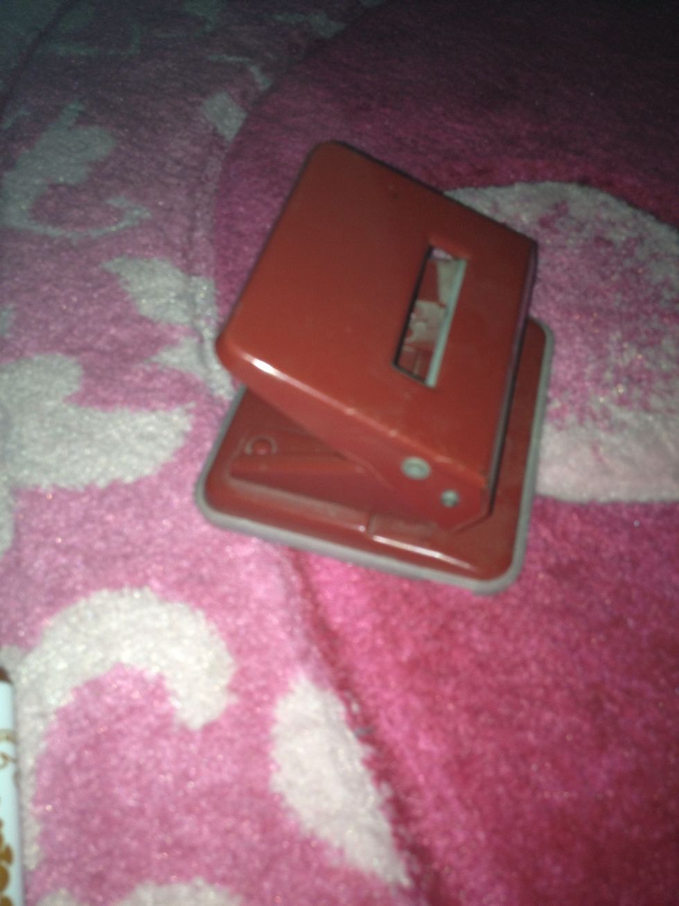 Use the paper punch to punch the corners of the triangles