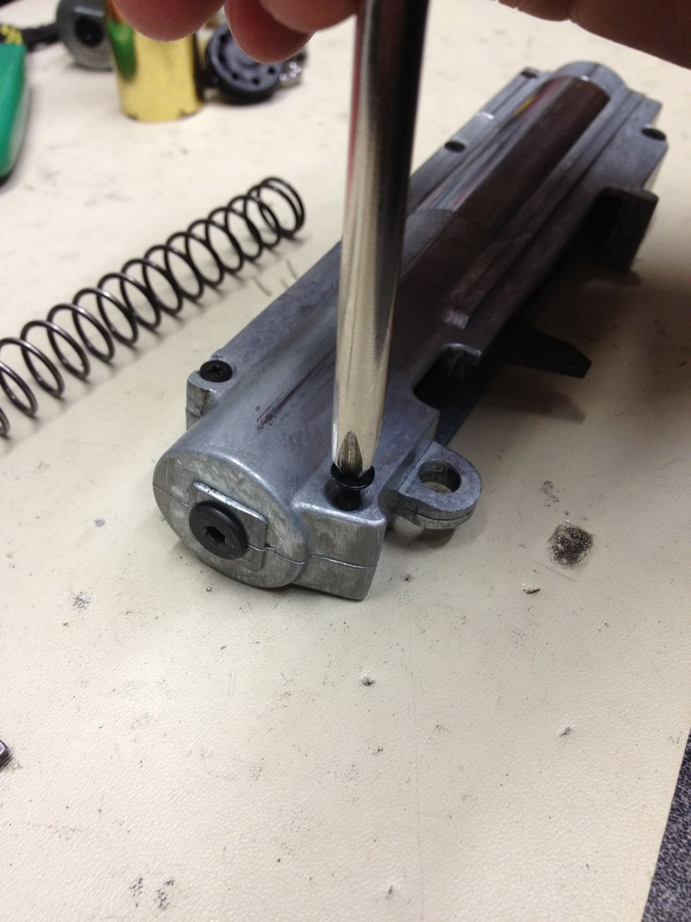 Use the Phillips #2 screwdriver to loosen the 2 larger screws on the bottom of the gearbox. (Look closely for the 2 bigger screws)