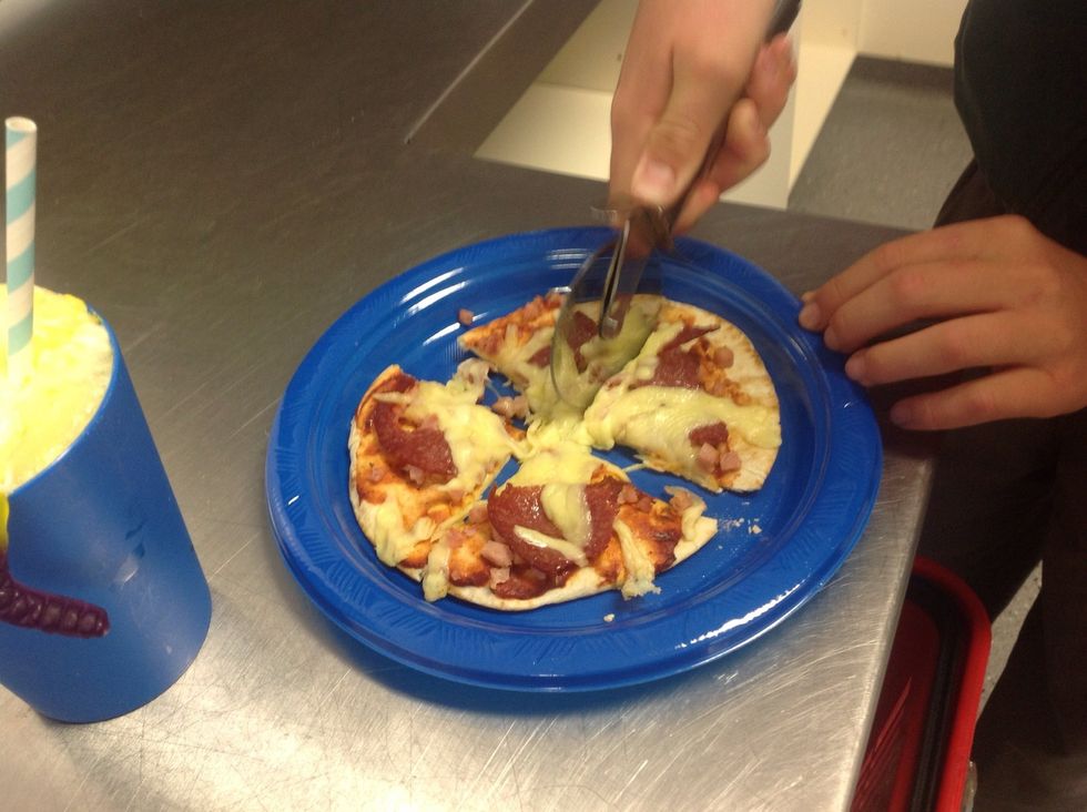 Use the pizza cutter to cut the pizza