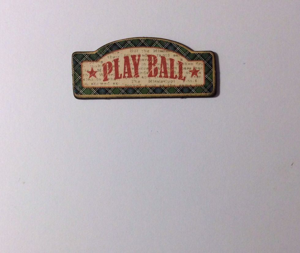 Use the play ball element from the chipboard 2 pack and ink the raw edges with black soot distress ink.