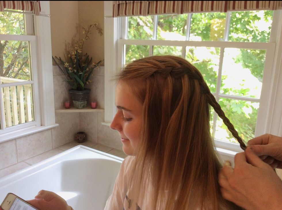 Use the rest of the three strands to normally braid your hair all the way to the bottom, and use a pony tail holder at the end.