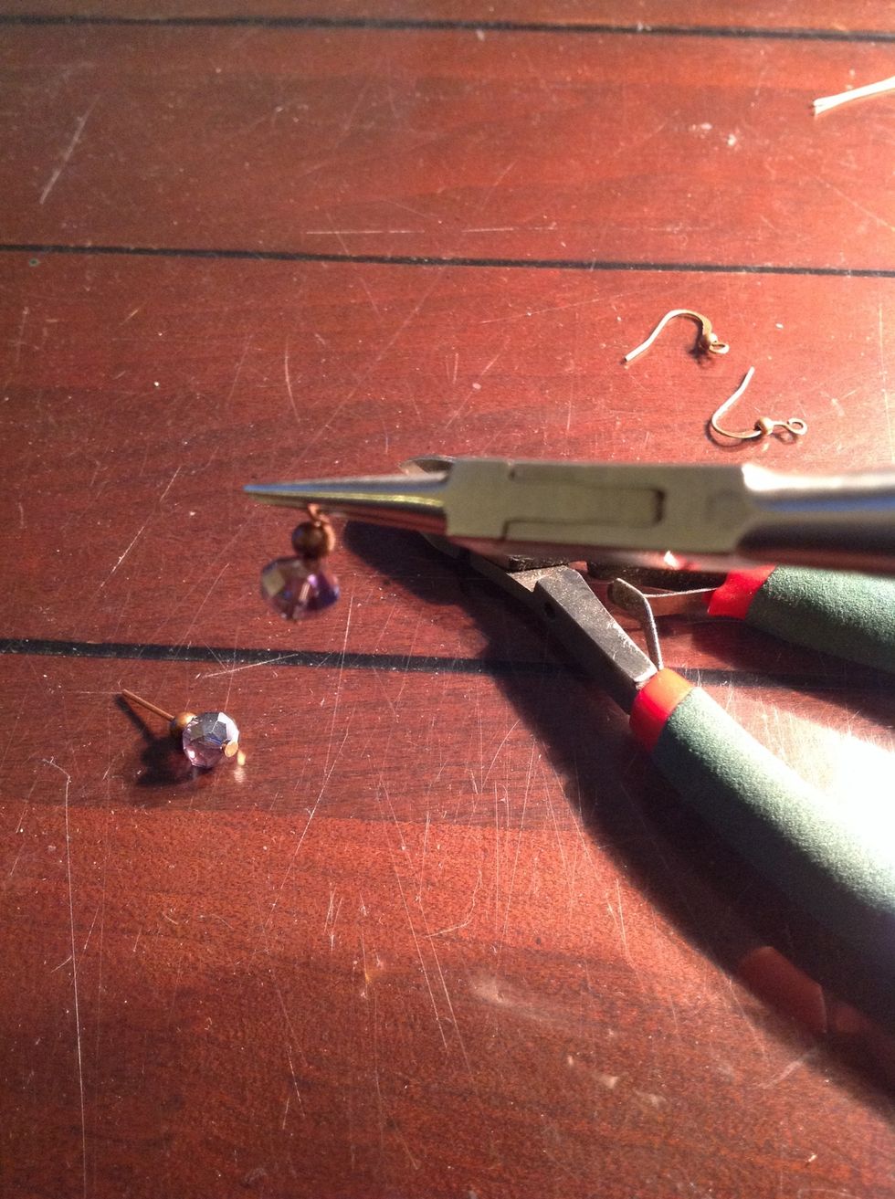 Use the round nosed pliers and roll the headpin wire down towards the beads until the cut end meets the beads