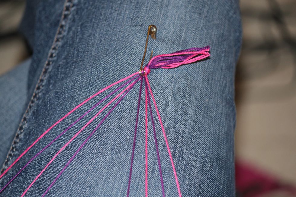 Use the safety pin to attach the string to your pants. Line the strings up in this order. The outside color is the color of the hearts.