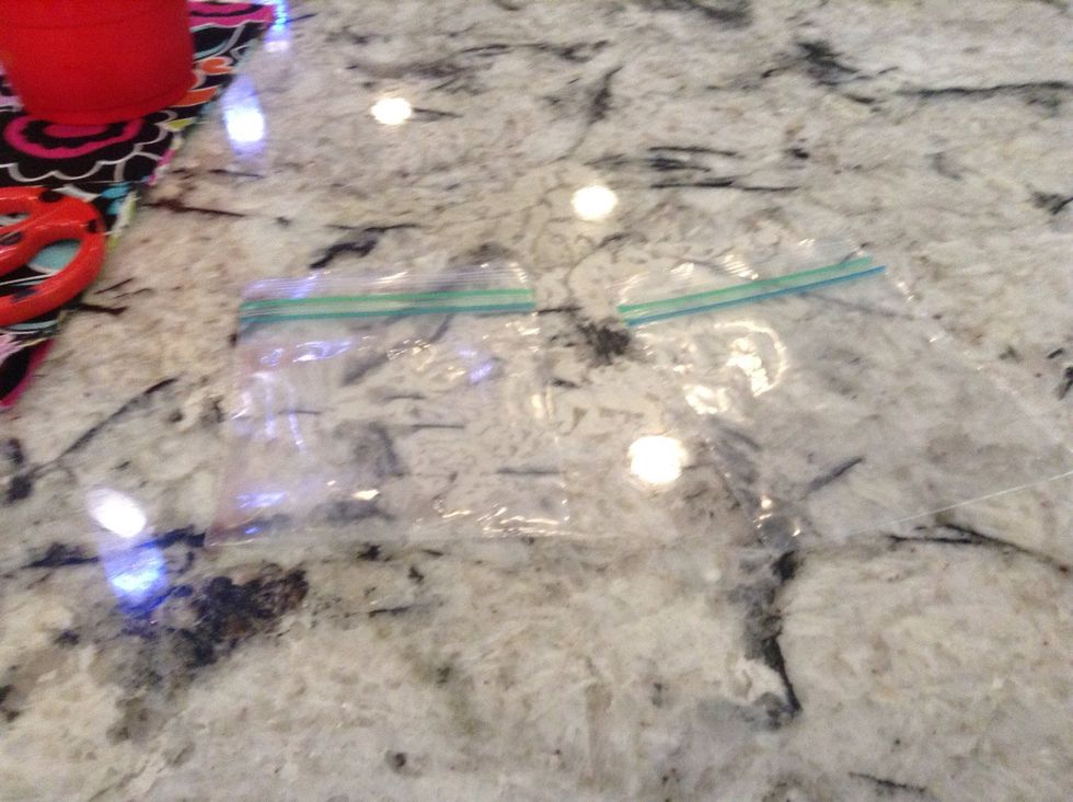 Use the scissors to cut down the middle so there are two parts of the bag