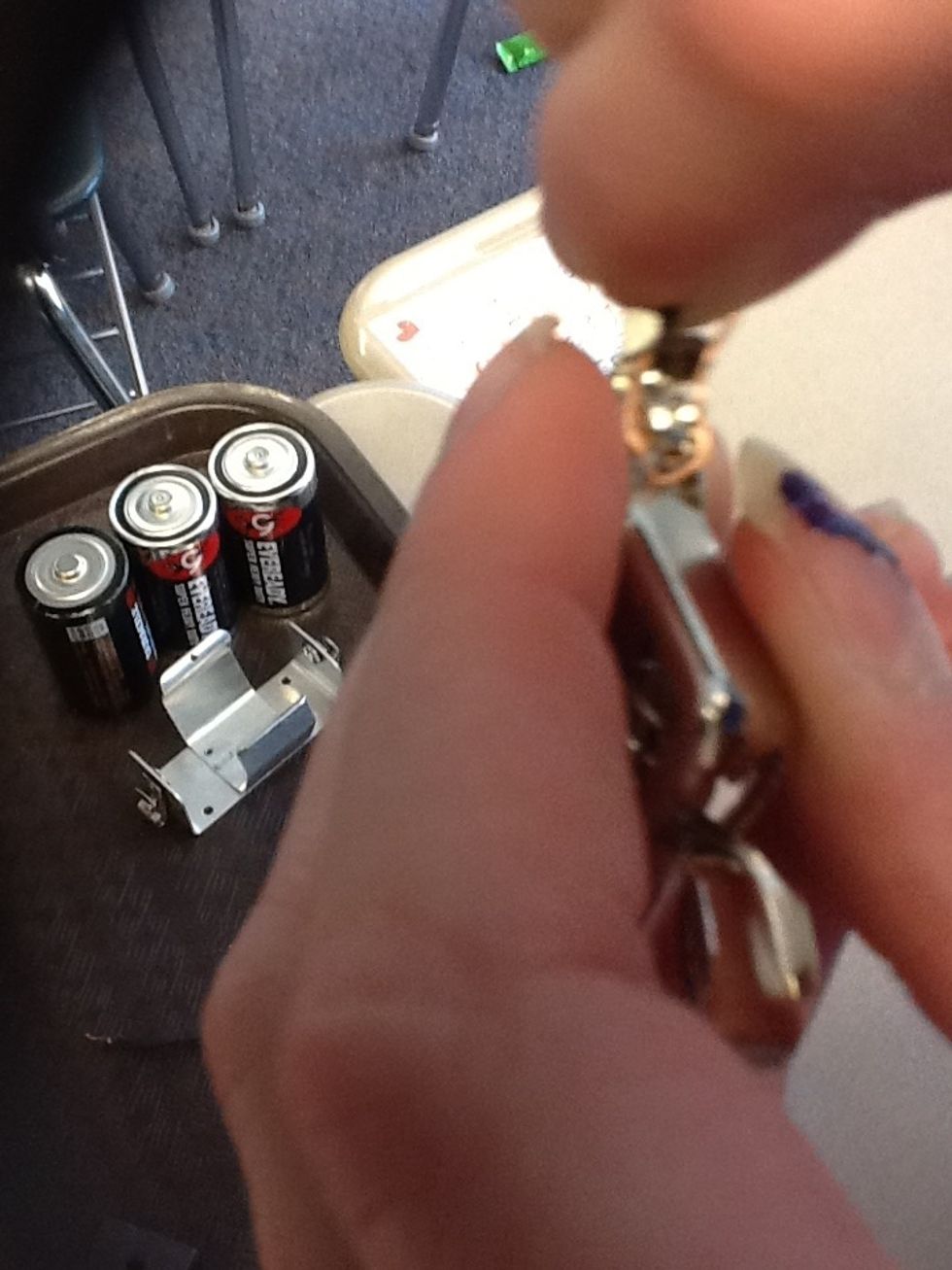 Use the screwdriver to make the screw lose. Note: DO NOT TAKE THE SCREW OUT.Then take a coated copper wire and wrap it around the screw (do not cover the whole screw).