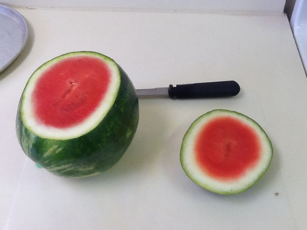 Use the serrated knife to cut about 1/5 off one side of the watermelon. This will be the base of the mother swan. The piece you have cut off will be used for the head, so keep it.