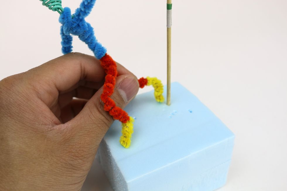 Use the skewer as a tool to make two holes for both feet so your figure can stand on it's own.