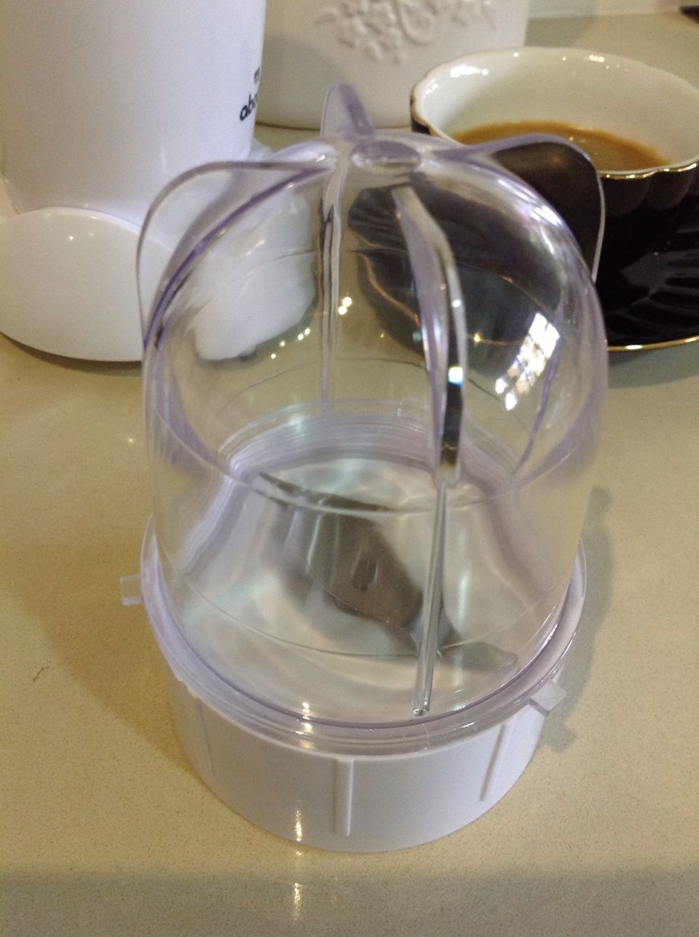 Use the small bullet cup with the flat blade to froth the milk.