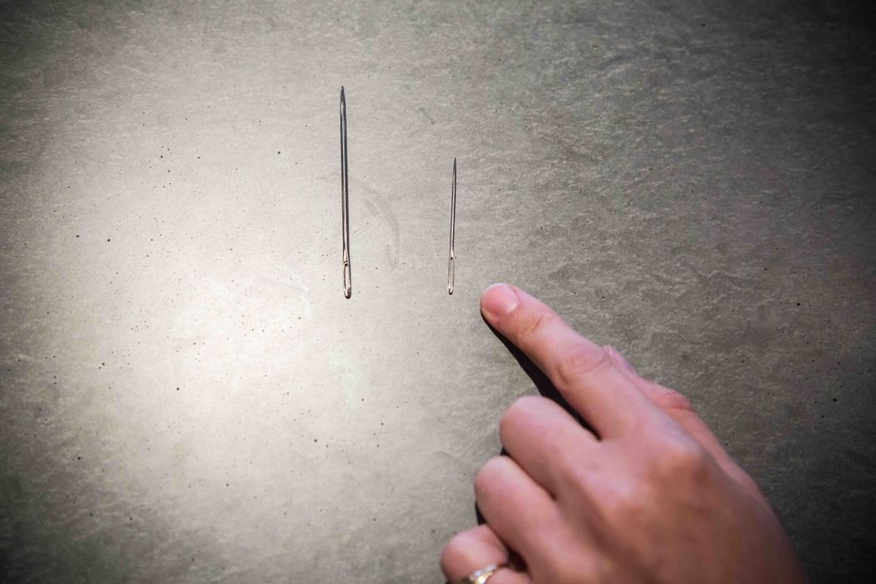 Use the smaller needle first to stitch to the heart together. The larger needle will be used to string the stuffed hearts together as a garland.