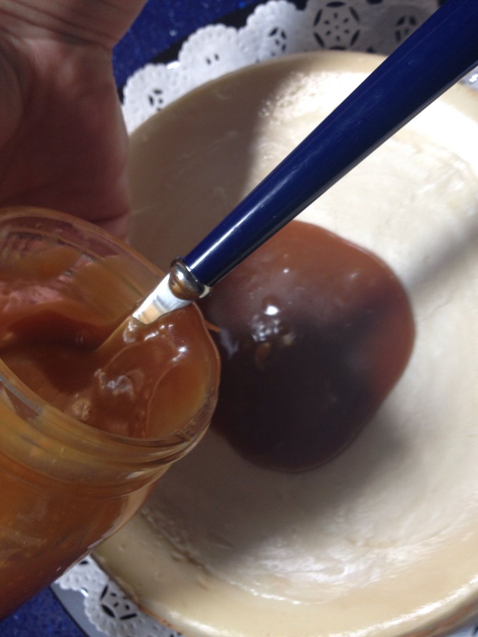 Use the spoon to guide the caramel out of the jar and put your preferred amount on the top of the cake