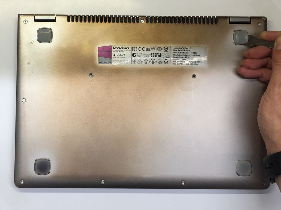 Use the Spudger (or similar) to remove the feet by inserting it into the gap at the edge of the rubber foot, then slide it under and lift. On my Yoga, this was easy, but yours maybe a little stickier