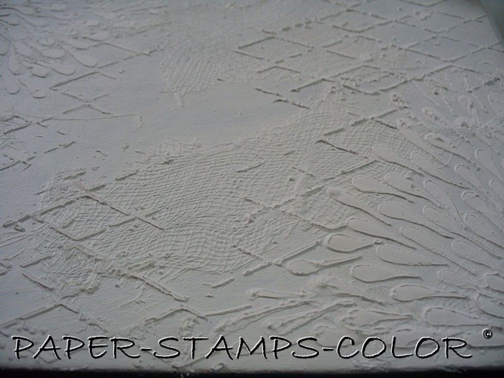 Use the stencil to add white structure paste to the surface and leave to dry.