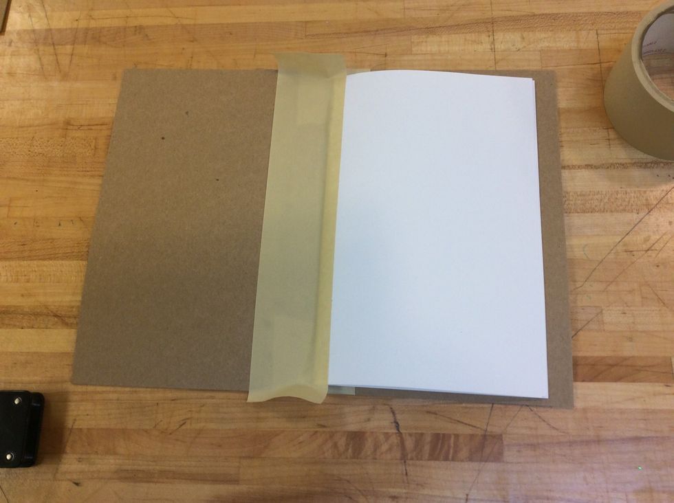 Use the tape in the center, going from top to bottom, and covering from 1/4 to 1/2 inch of the paper booklet.