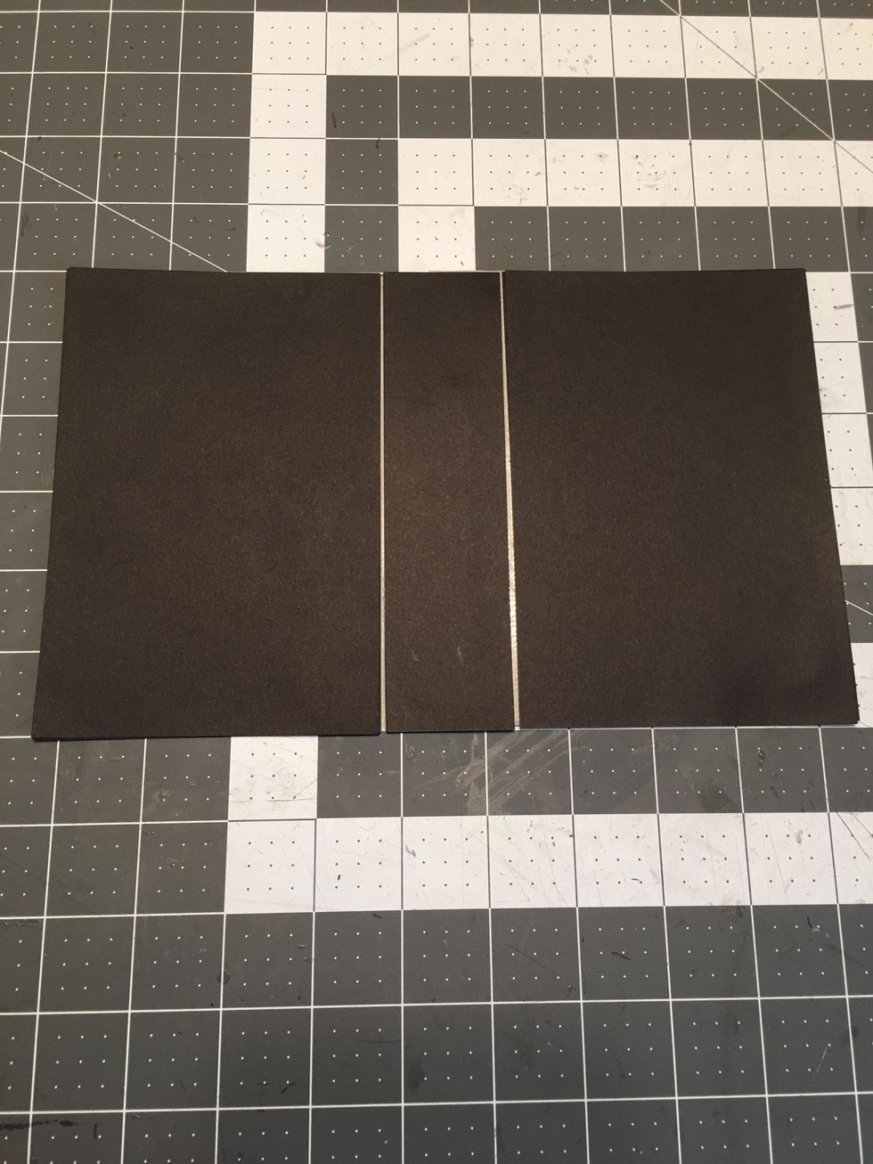 Use the tape to attach the 3 pieces together as shown. Make sure to leave about an 1/8" gap between the pieces.  Cover the back side of the pieces over the "hinge areas" with another strip of tape.