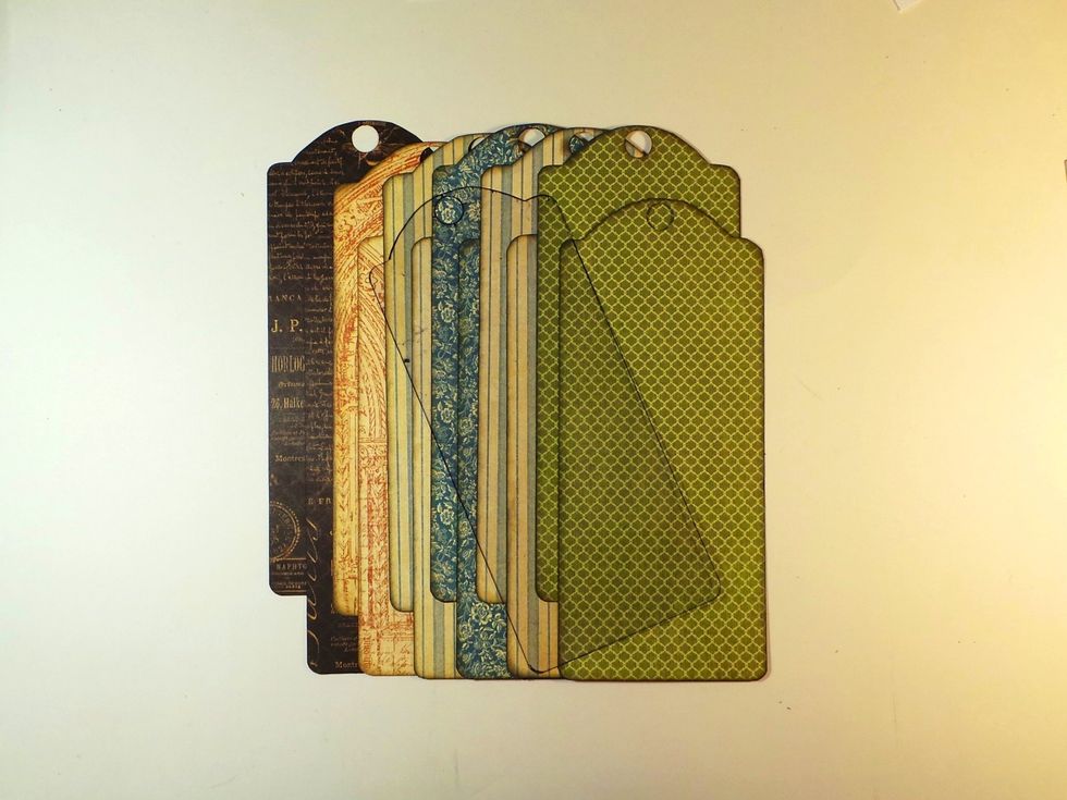 Use the template we created in Step 4 to cut 12 backgrounds. I'm using the black for the covers. Ink edges if/as desired (throughout the project I used Distress Ink Gathered Twigs and Black Soot)