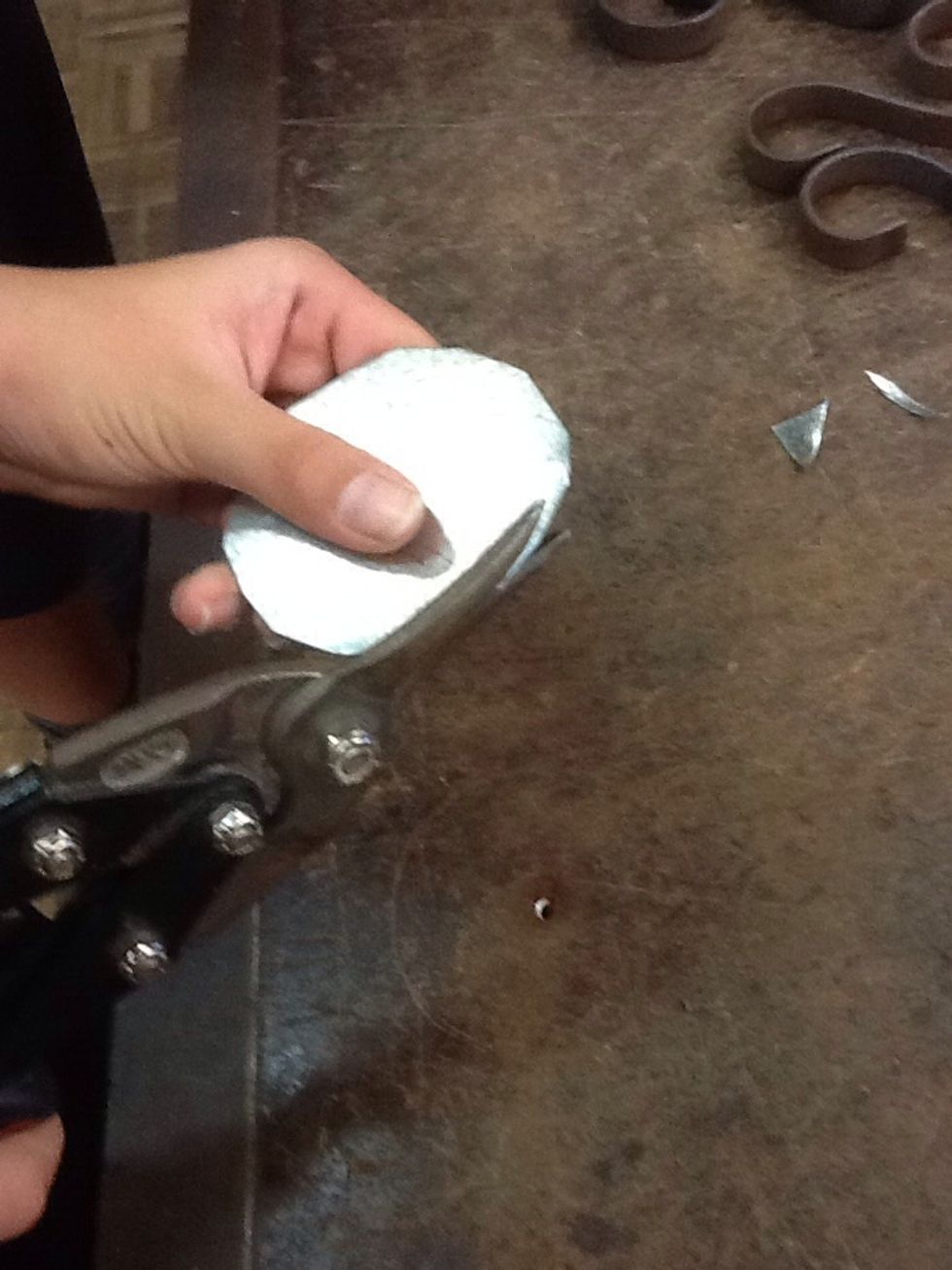 Use the tin snips and cut out the circle as well as you can