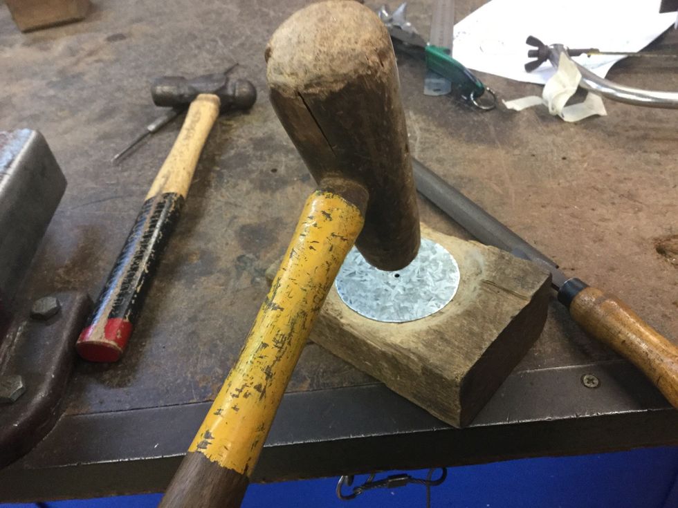 Use the tinmans mallet to mould the sheet metal so it's dented and can catch the wax