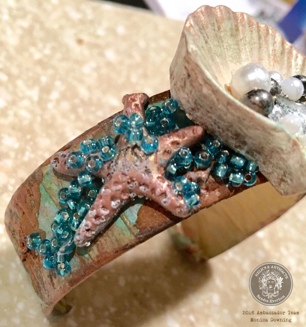 Use the toothpick and clear tacky glue to apply the beads outside of the shell. I used the teal chalk edger along the edges of the shell.