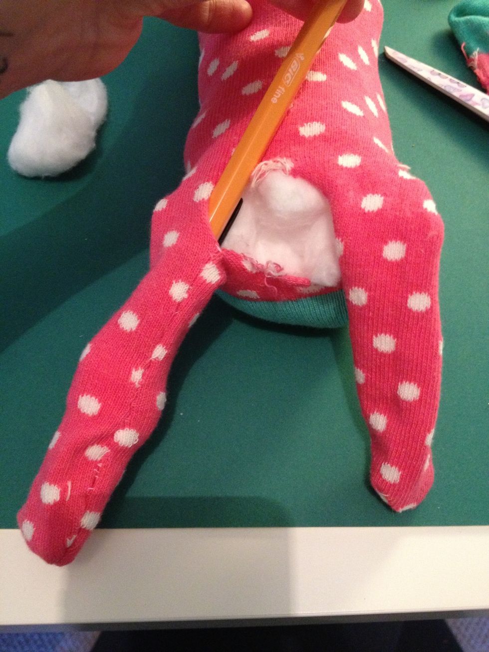 Use the top of the pen to get the cotton wool to the bottom of the legs.