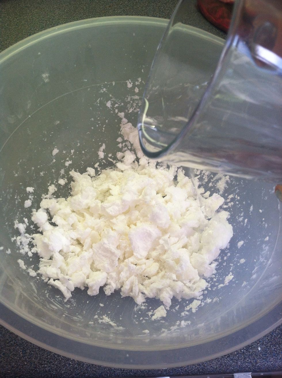 Use the warm water and pour in little bits at a time. Mix with a spoon!