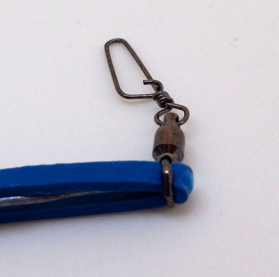 Use the wire tool to carefully push the first rubber band through the eye of the swivel. Remove the wire tool and pull about 1 cm through the eye with your fingers.
