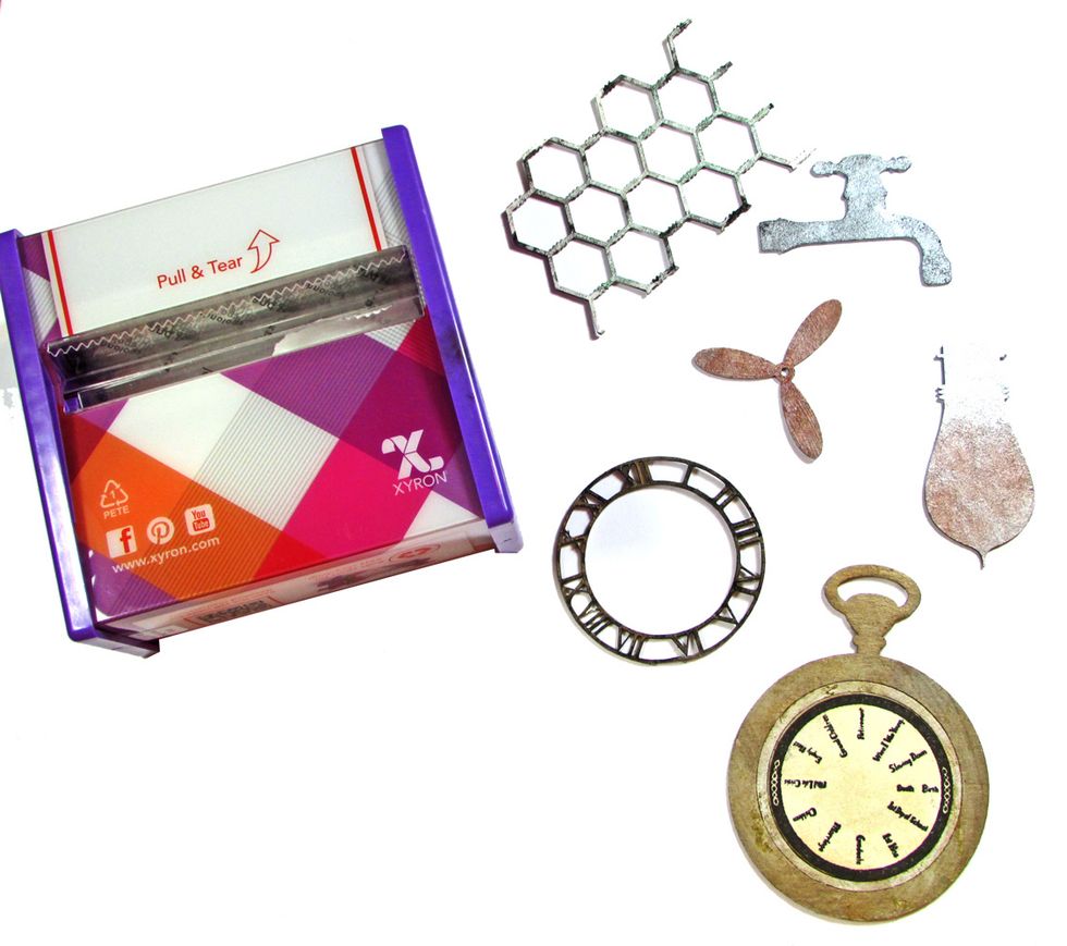 Use the Xyron 3" Sticker Maker to add adhesive to the chipboard pieces.