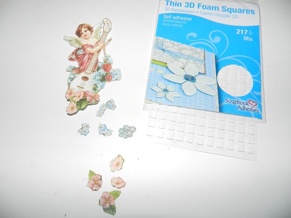 Use Thin 3D Foam Squares to adhere the flowers and wings and this way you can get more dimension on your project.