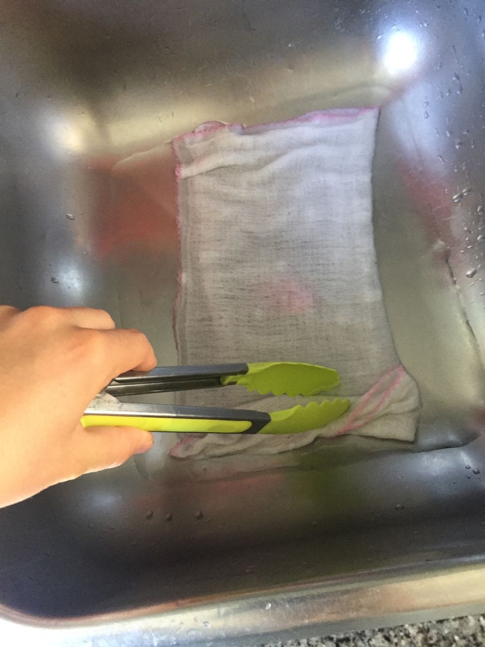 Use tongs to make sure all the towel is soaked