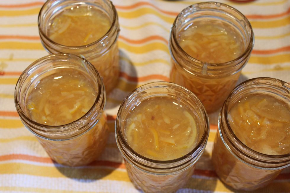 Use tongs to remove equipment from pot, drain well, and set on towel. Ladle mix into each jar and wipe excess with a damp paper towel. Put lids on top, add rings, and screw tightly.