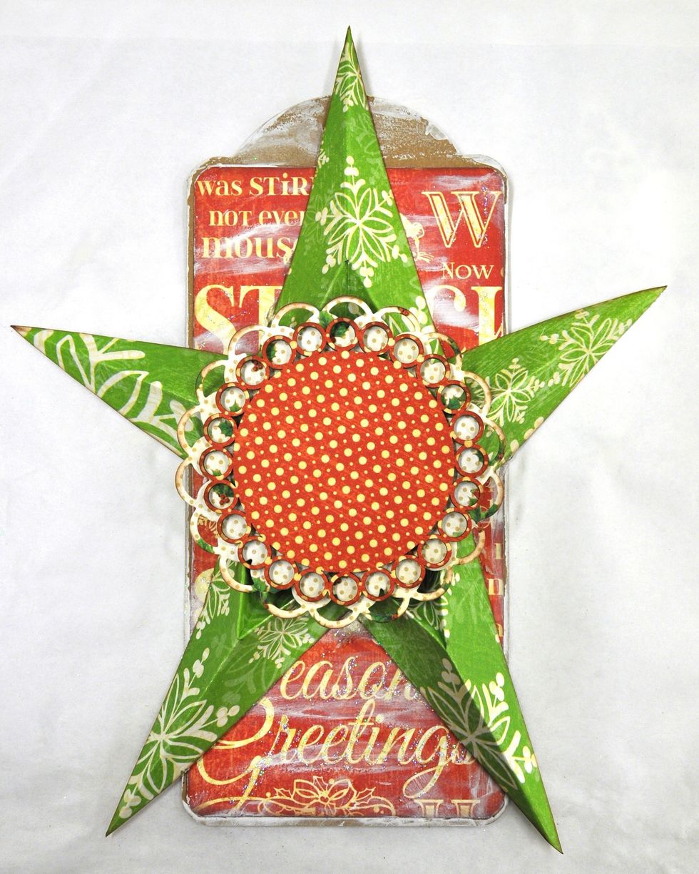 Use two circle dies and cut a 3 3/4 and a 3 1/4 doily out of chipboard & paper. Glue the papers to the chipboard, adhere the largest one to your star. Use foam squares to attach the smaller one.