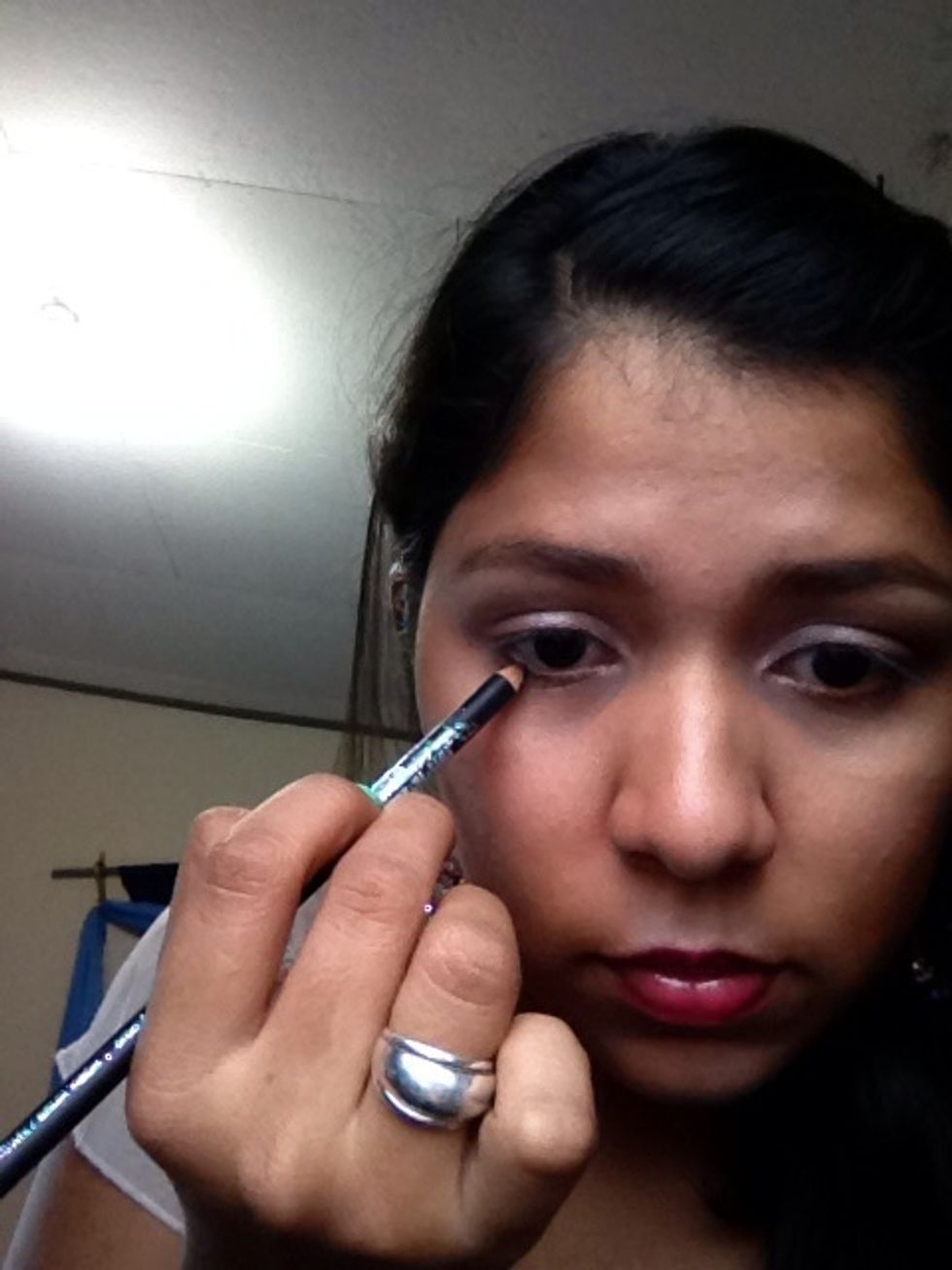 Use Wet & Wild pencil to apply eyeliner to the water line and to the upper part.