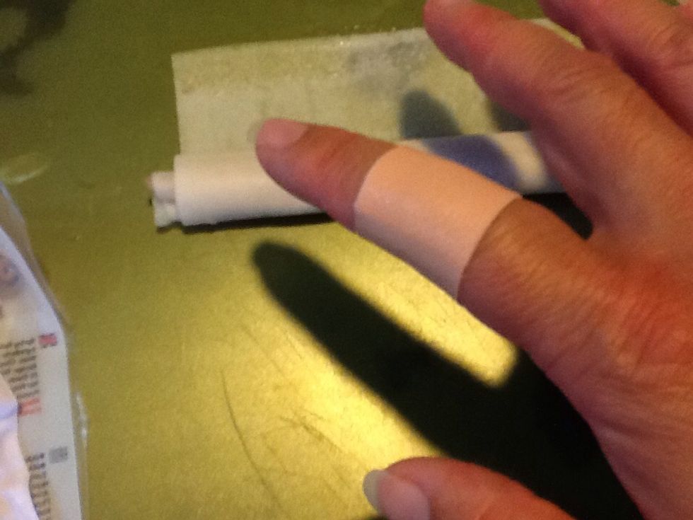 Use you finger dipped in a little water to moisten the end of the wrapper. Finish rolling and seal seam.