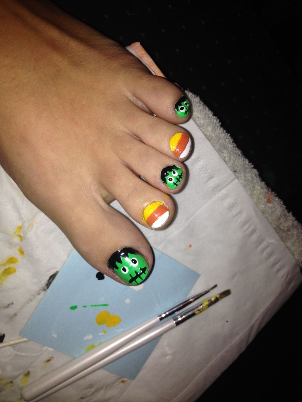 Use your black to make mouths and pupils for your Frankenstein nails. For the mouths just make 3 vertical lines, then add a horizontal line going through them.