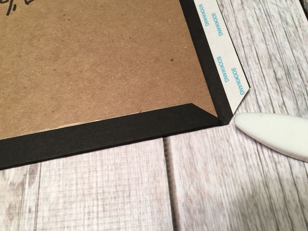 Use your bone folder or fingernail to press any card stock that sticks out at the mitered corners.