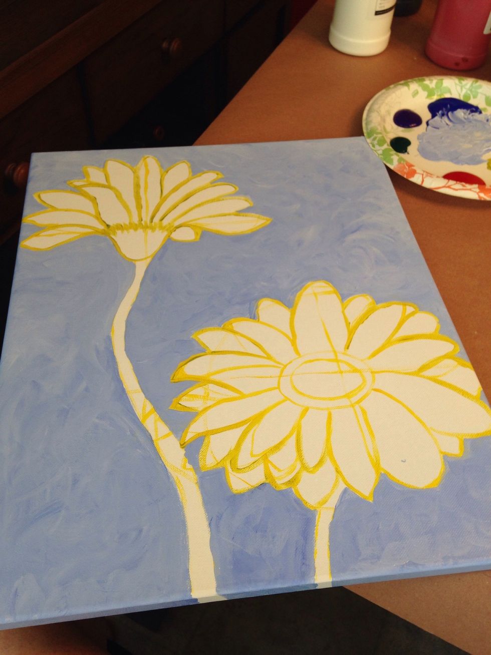 Use your brush to add texture to the color by swirling the brush or adding various shades of blue mixed with white. Also paint the sides of the canvas if it's a wrapped canvas.