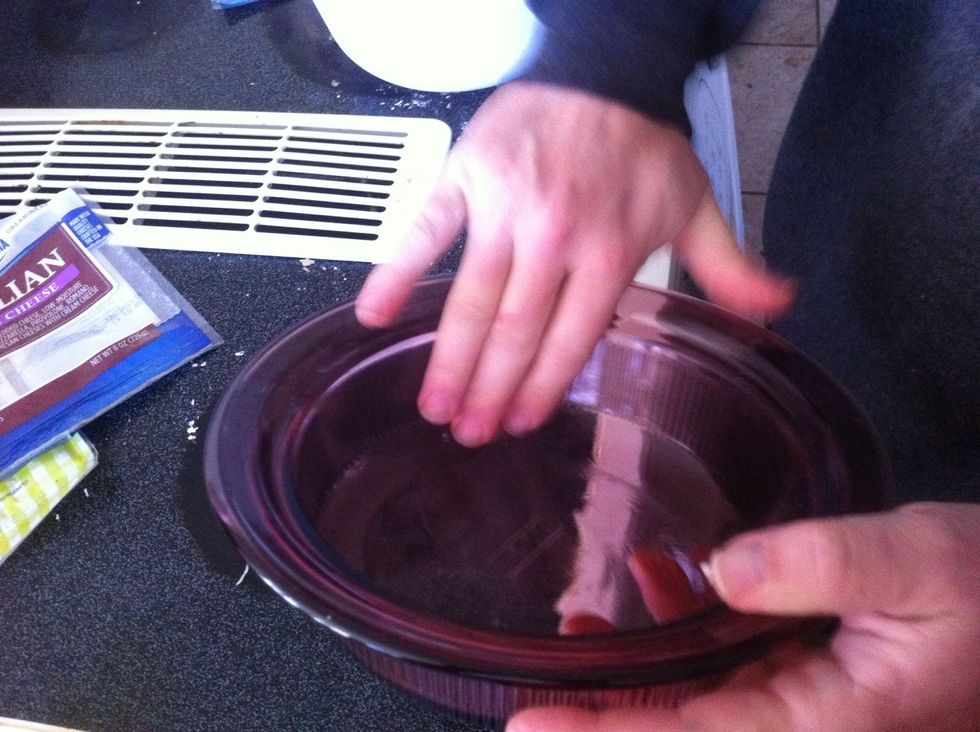 Use your "clean" finger to disperse the oil all around the dish.