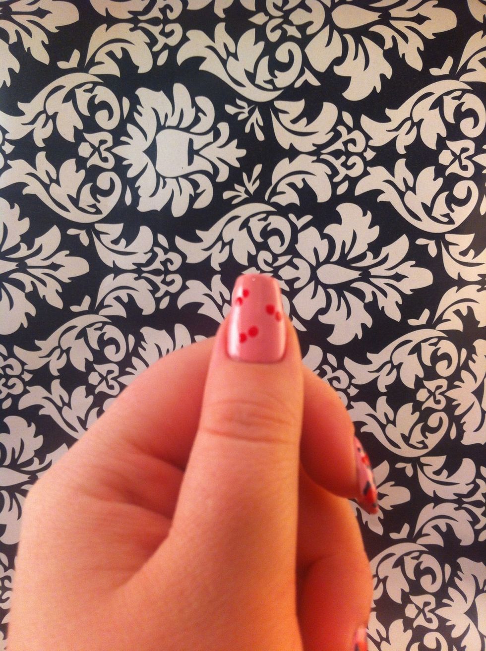 Use your dotting tool and red polish to create sets of two dots on your nail.