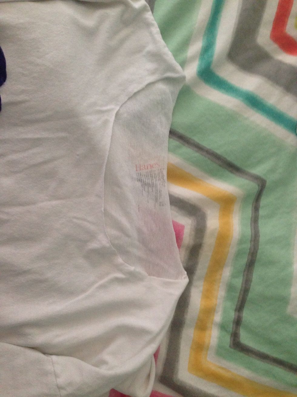 Use your fabric scissors to cut the collar off of the shirt. Then pull on the t-shirt where you removed the collar so the t-shirt won't fray.