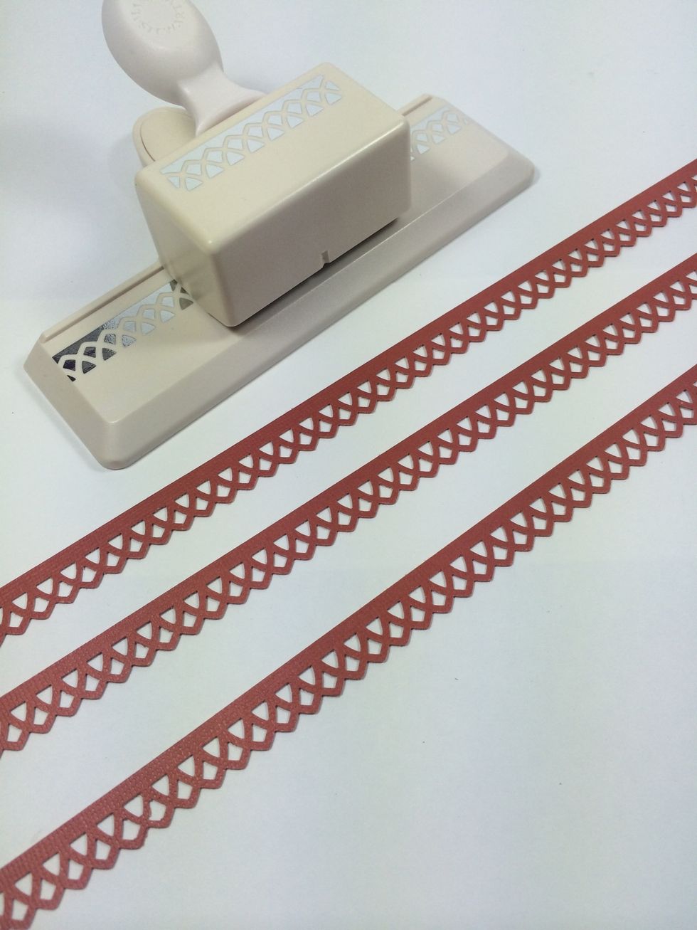 Use your favorite border punch to make some trims for each box. I cut from a deep orange color.