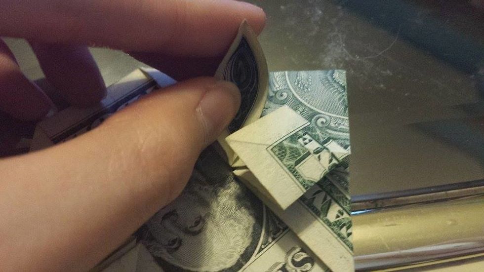 Use your finger to open the left small triangle.