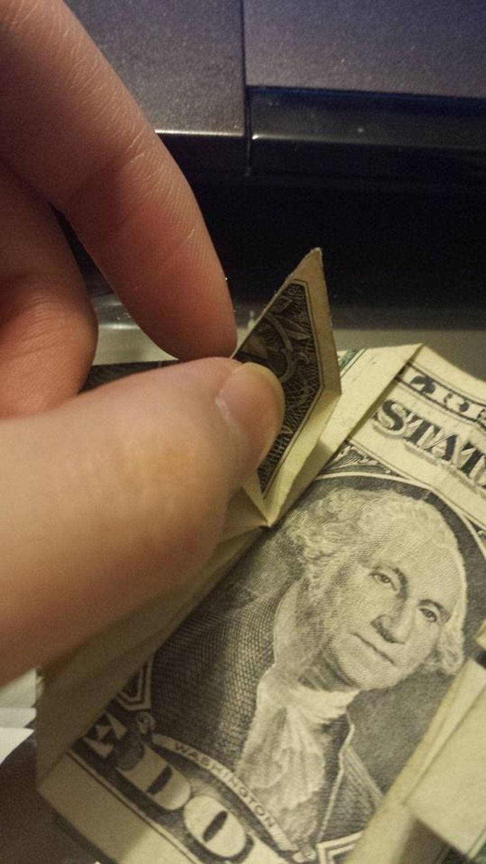 Use your finger to open up the small triangle.