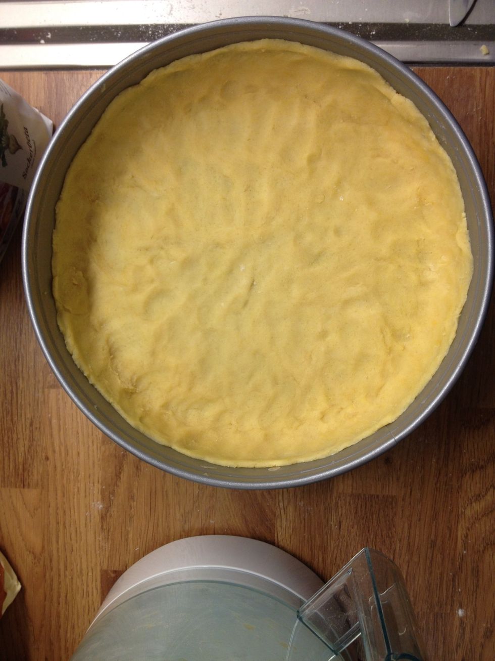 Use your fingers to apply the dough in the cake mold. If it gets sticky, use some extra flour. Use the kind of mold where you can remove the side. Put in the fridge for 30 minutes.