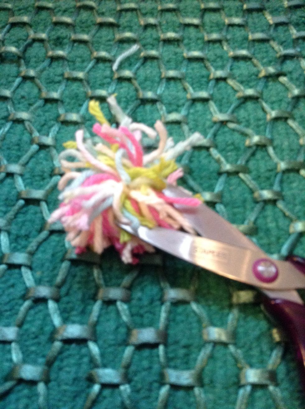 Use your fingers to move the yarn around into a circle shape and then trim the yarn so its even!