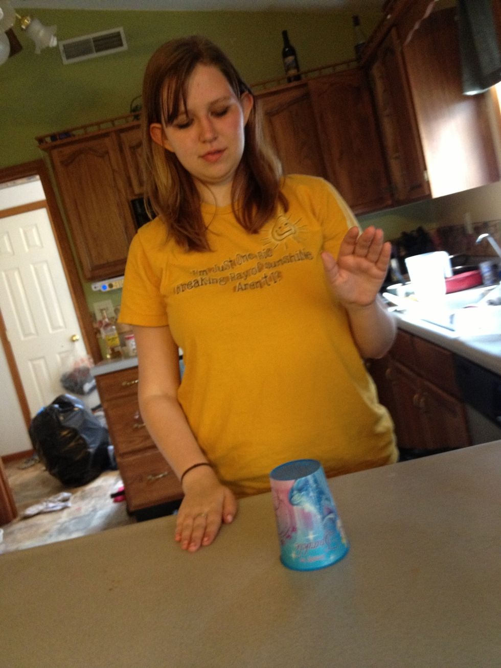 Use your hands to either hit the counter or the top of the cup 3 times