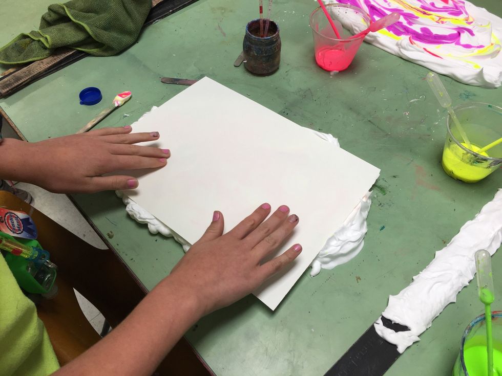 Use your hands to press out all the air bubble. You don't have to press hard, but you want to make sure the paint touches the paper thoroughly.