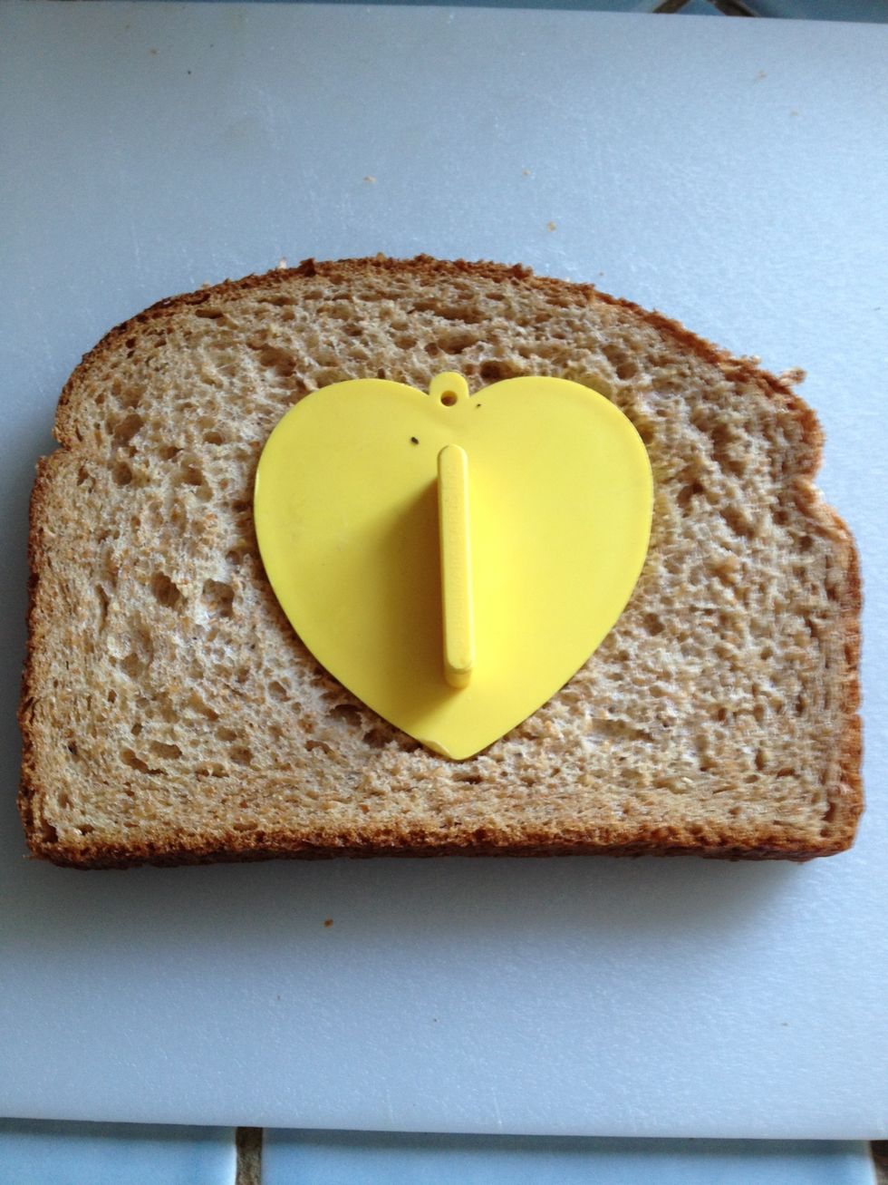 Use your heart \u2764 cookie cutter to cut out a \u2764 hole in the bread.