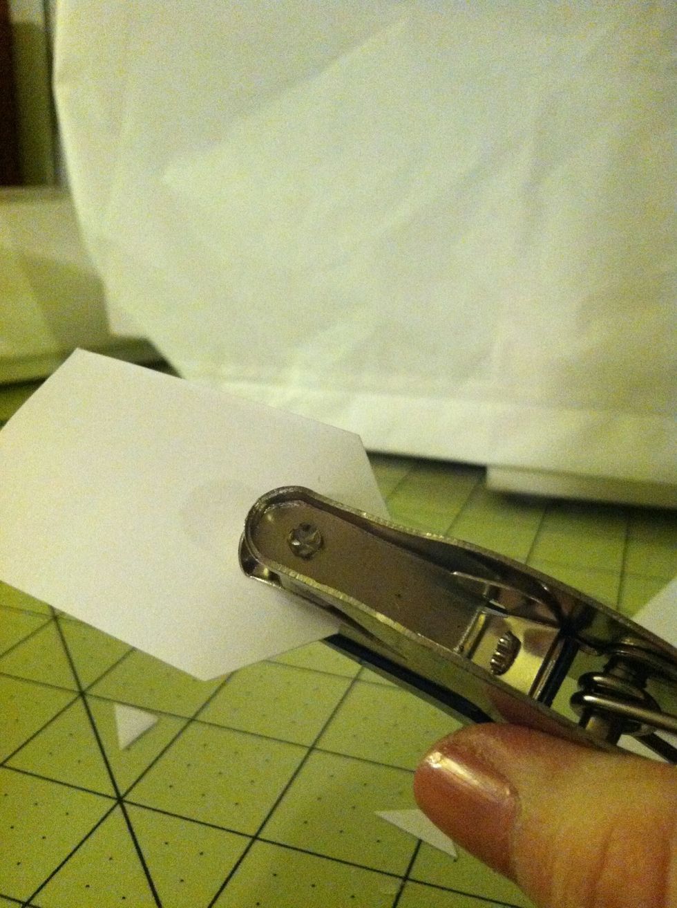 Use your hole puncher in between the corners we just cut.