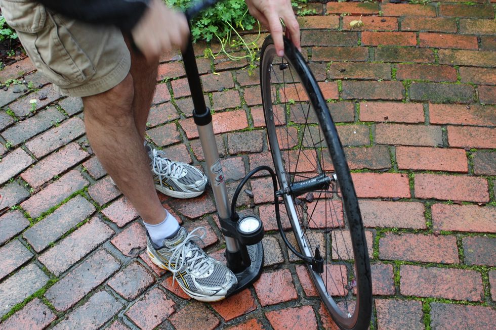 Use your manual pump or a gas canister to inflate the tire to the pressure indicated on the tire rims or the box the tube came in. Put your tire back onto the bike. (Don't forget to reset that brake.)
