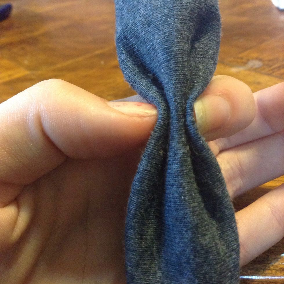 Use your other hand to fold the sides up along your fingers, and pinch it together